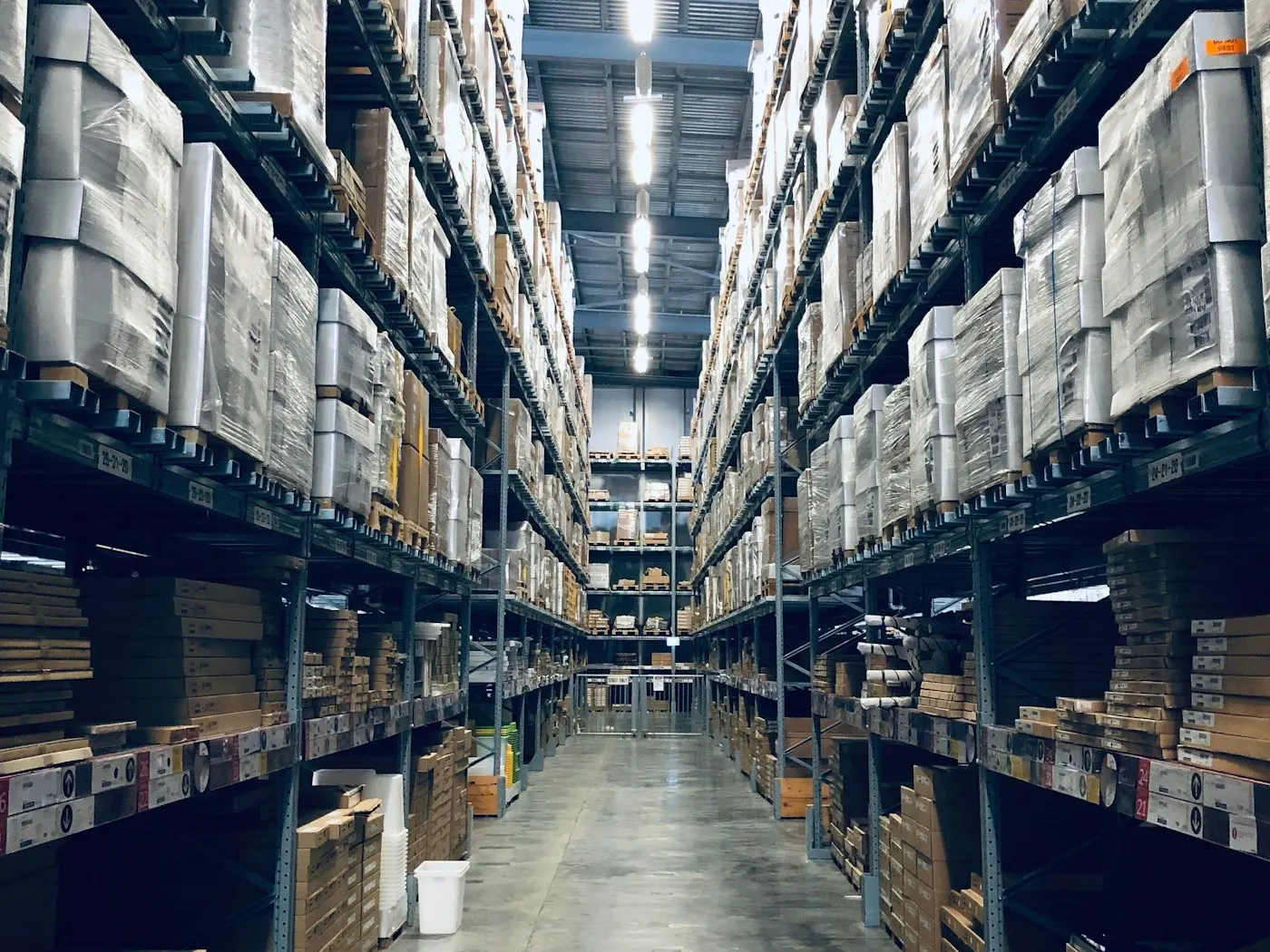 Racked UAE distribution warehouse aisle stocked with palletised business supplies